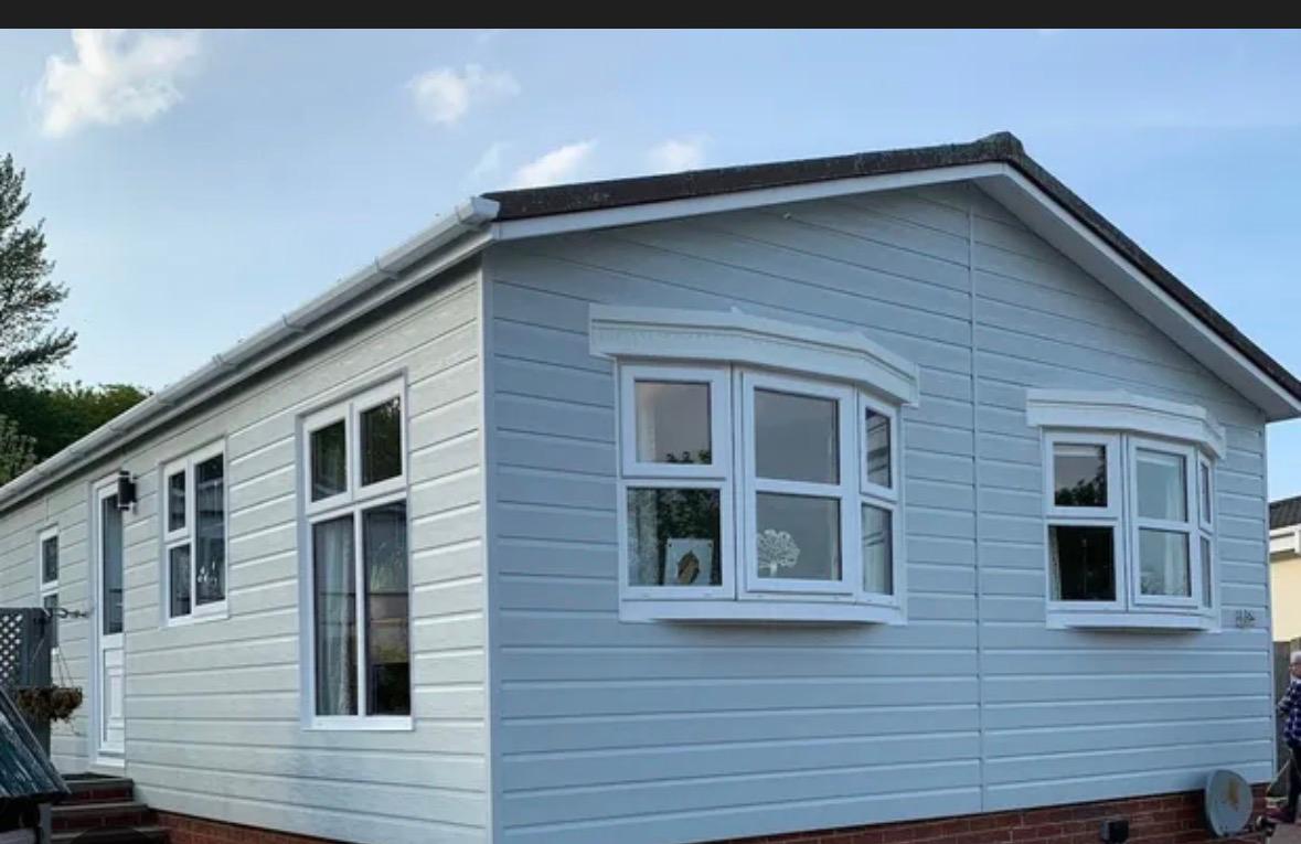 Park home with fresh exterior cladding and new white windows